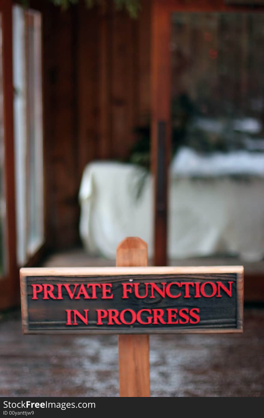 Wooden sign with red text letters warning of private function in progress. Wooden sign with red text letters warning of private function in progress