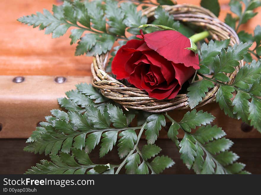 Red Rose decoration in a wreath and green leaves