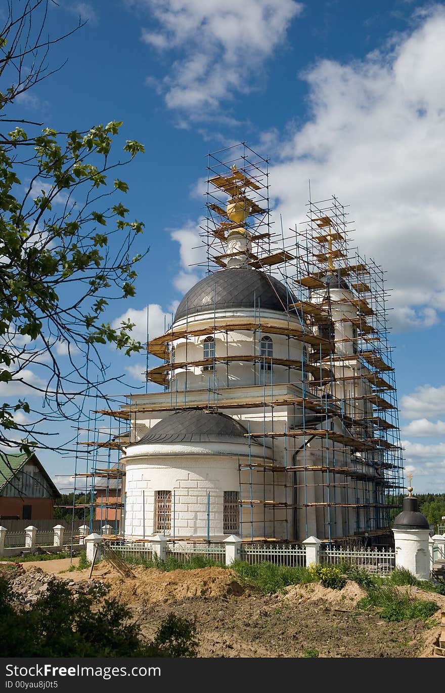 Restoration of Christian church in village in the summer