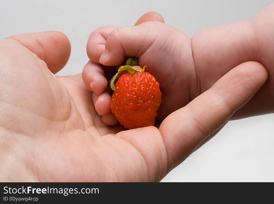 Strawberry in hand, dad and baby