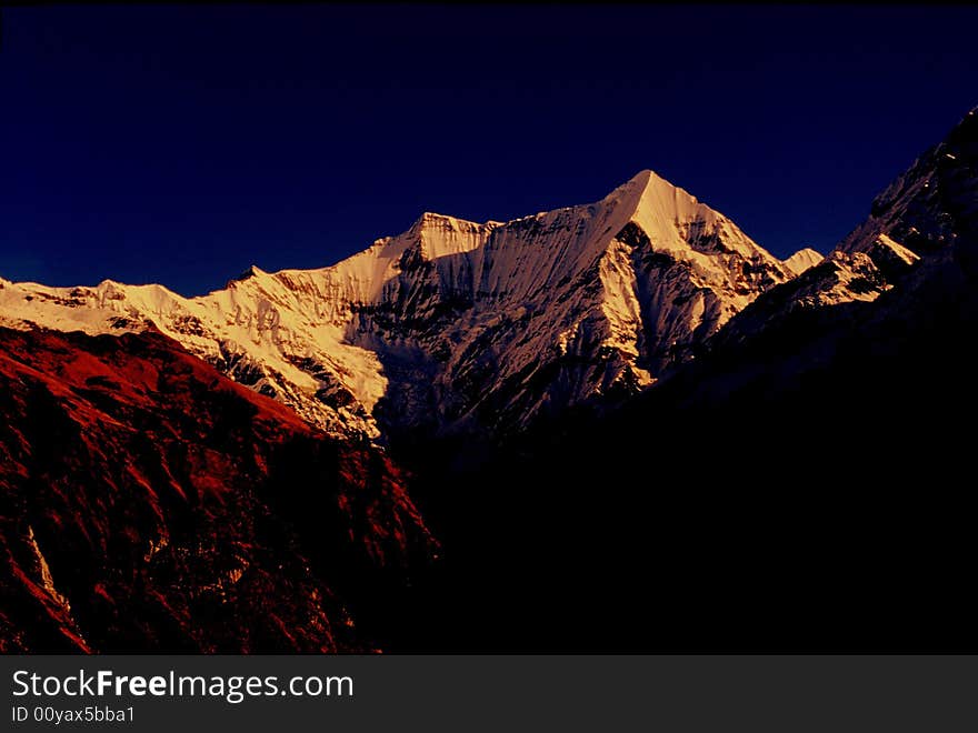 Mt Panwalidwar(6663m) is one of the beautiful peak of Uttarnchal. This was taken from Sundardhunga top when the sun rays started to enlighten the beautiful basin. One can trek to the Sunderdhunga Glacier while in the Pindar region. It is a tough trek as compared to Pindari and Kaphini. Sunderdhunga means the valley of beautiful stones. This valley is situated to the west of the Pindar valley and has two glacier to offer to trekkers and nature lovers, namely Maiktoli and Sukhram.

The route upto village Khati is common for both Pindari and Sunderdhunga glacier. The peaks which offer a spectacular view when seen from here, are Tharkot (6100m), Mrigthuni (6856m), Maiktoil (6803m) and Panwalidwar (6663m).Sunderdhunga is approximately 24 kms from the village Khati.From Khati one has to go to village Jatoli,which is 7 kms away.Jatoli is the first night halt enroute to Sunderghunga Glacier.From Jatoli upto Dhungia Dhaun,about 8 kms. is a tough trek.

One should spend the night in Dhungia Dhuan either in shepherd huts or in pitched tents. Beyond Dhungia Dhuan, it is necessary to take a guide even for experienced and professional trekkers. The next halt is Kathalia, which is 6 to 7 kms. from Dhungia Dhaun. From Kathalia one can go to both Sukhram and Maiktoli glaciers. They are in opposite directions,7 kms. from Kathalia.

Trek
Base Camp
Song to Sunderdhunha Glacier 54kms.
Song to Loharkhet 3kms.
Loharkhet to Dhakuri 11kms.
Dhakuri to Kathi 8kms.
Kathi to Sundardhunga Glac. Mt Panwalidwar(6663m) is one of the beautiful peak of Uttarnchal. This was taken from Sundardhunga top when the sun rays started to enlighten the beautiful basin. One can trek to the Sunderdhunga Glacier while in the Pindar region. It is a tough trek as compared to Pindari and Kaphini. Sunderdhunga means the valley of beautiful stones. This valley is situated to the west of the Pindar valley and has two glacier to offer to trekkers and nature lovers, namely Maiktoli and Sukhram.

The route upto village Khati is common for both Pindari and Sunderdhunga glacier. The peaks which offer a spectacular view when seen from here, are Tharkot (6100m), Mrigthuni (6856m), Maiktoil (6803m) and Panwalidwar (6663m).Sunderdhunga is approximately 24 kms from the village Khati.From Khati one has to go to village Jatoli,which is 7 kms away.Jatoli is the first night halt enroute to Sunderghunga Glacier.From Jatoli upto Dhungia Dhaun,about 8 kms. is a tough trek.

One should spend the night in Dhungia Dhuan either in shepherd huts or in pitched tents. Beyond Dhungia Dhuan, it is necessary to take a guide even for experienced and professional trekkers. The next halt is Kathalia, which is 6 to 7 kms. from Dhungia Dhaun. From Kathalia one can go to both Sukhram and Maiktoli glaciers. They are in opposite directions,7 kms. from Kathalia.

Trek
Base Camp
Song to Sunderdhunha Glacier 54kms.
Song to Loharkhet 3kms.
Loharkhet to Dhakuri 11kms.
Dhakuri to Kathi 8kms.
Kathi to Sundardhunga Glac