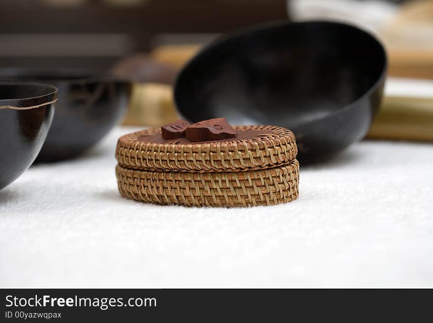 Wooden bowl and old bamboo woven chest over white. Wooden bowl and old bamboo woven chest over white