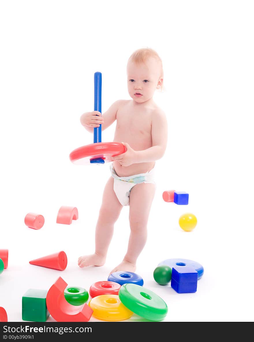 Portrait of a little boy playing with bright geometric toys on playground. Image isolated on white with light shadows. Portrait of a little boy playing with bright geometric toys on playground. Image isolated on white with light shadows