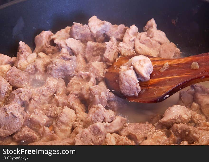 Preparation of meat at the pan close-up