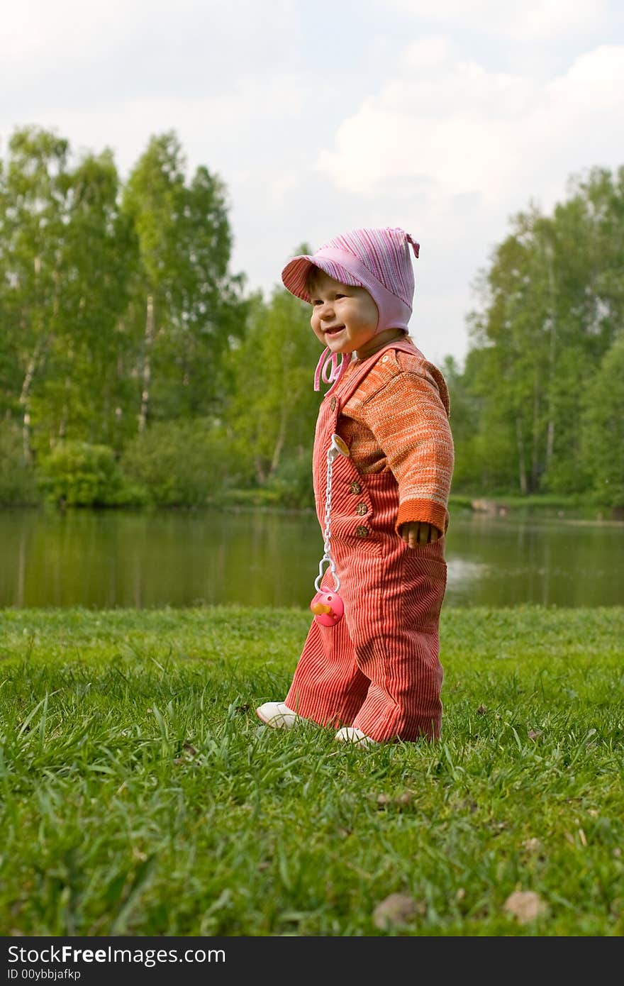 Happy child on green meadow