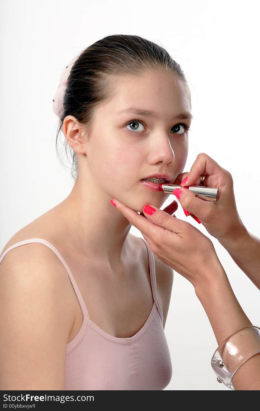 Teenager whith brackets on her tooth having make up