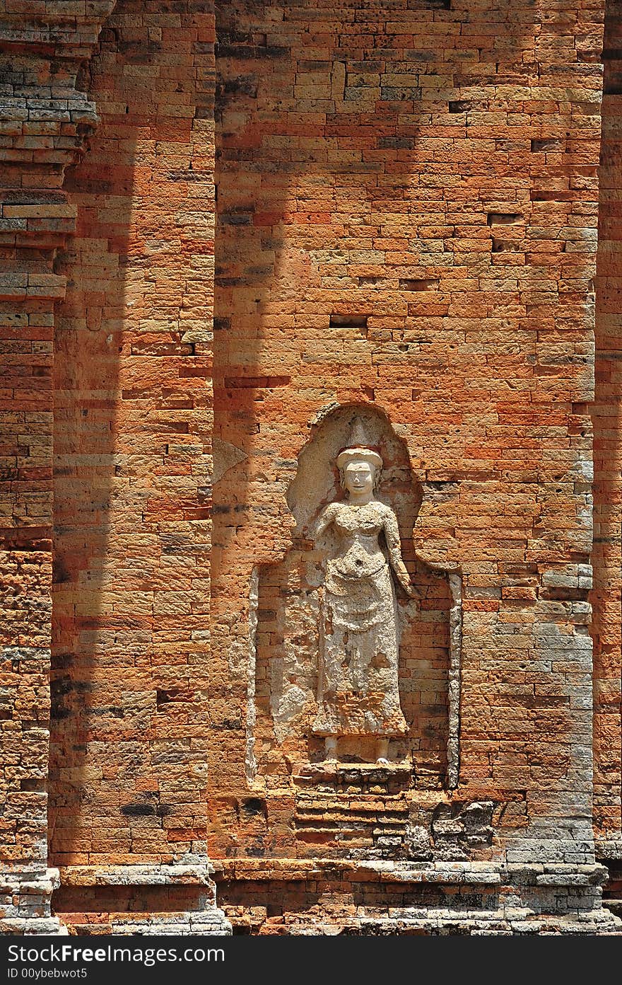 In Cambodia in the ancient city of Roulos the Hindu temple of Bakong was built in the 9th century by the king Indravarman I. View of the carved walls with one apsara. In Cambodia in the ancient city of Roulos the Hindu temple of Bakong was built in the 9th century by the king Indravarman I. View of the carved walls with one apsara