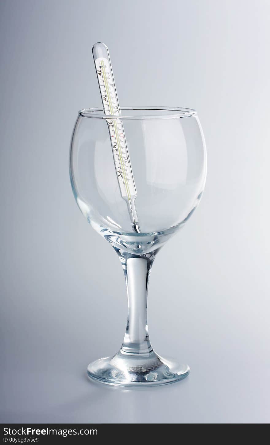 The thermometer in a glass glass on a white background. The thermometer in a glass glass on a white background