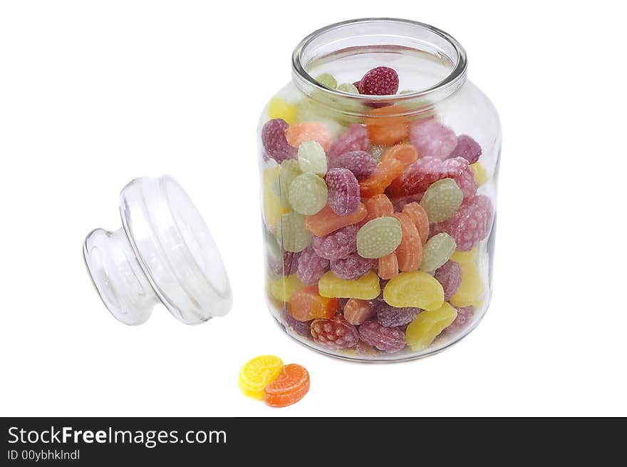 Multicolor bonbons in glass pot on the white background