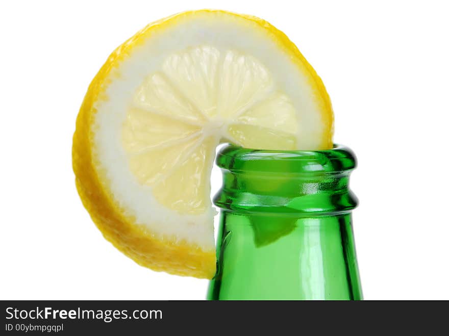 Fresh cut lemon slice on green bottle