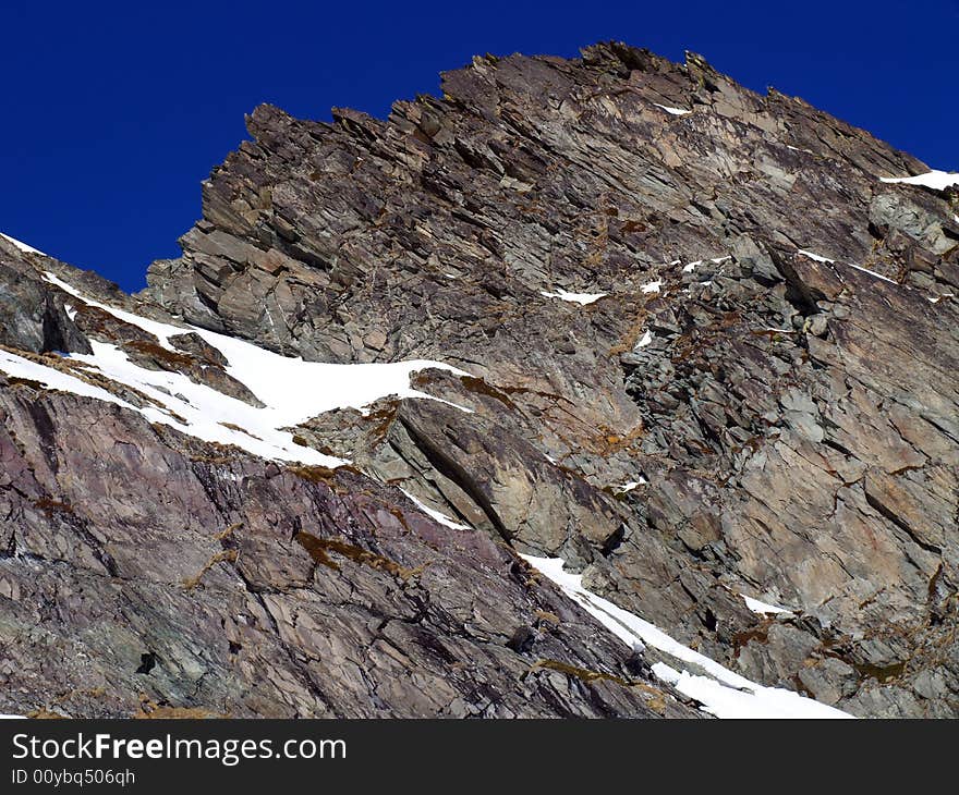 Rocks of a high mountain with blue sky