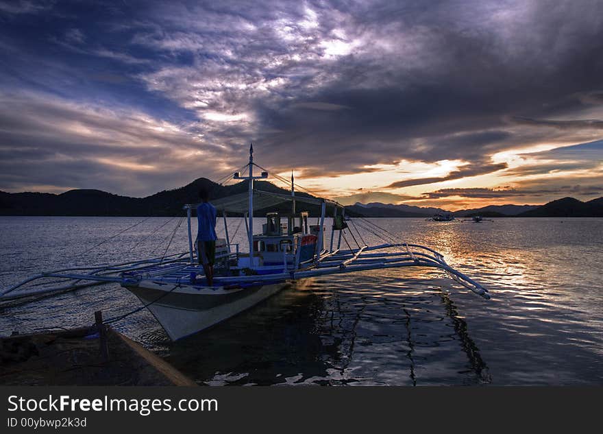 A shot of a boy and his boat preparing to leave. A shot of a boy and his boat preparing to leave