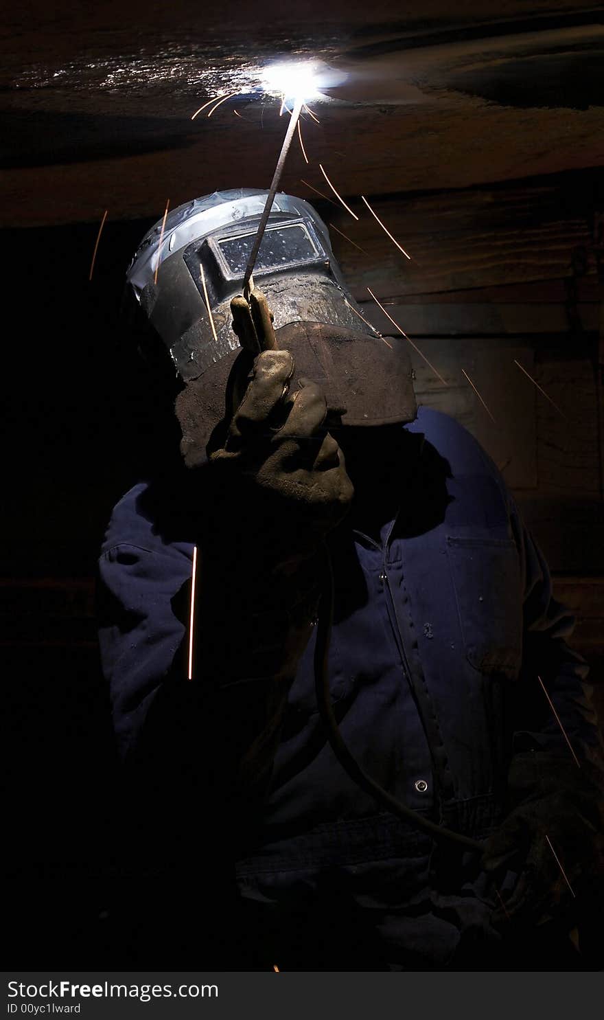 A welder working at shipyard at night. A welder working at shipyard at night