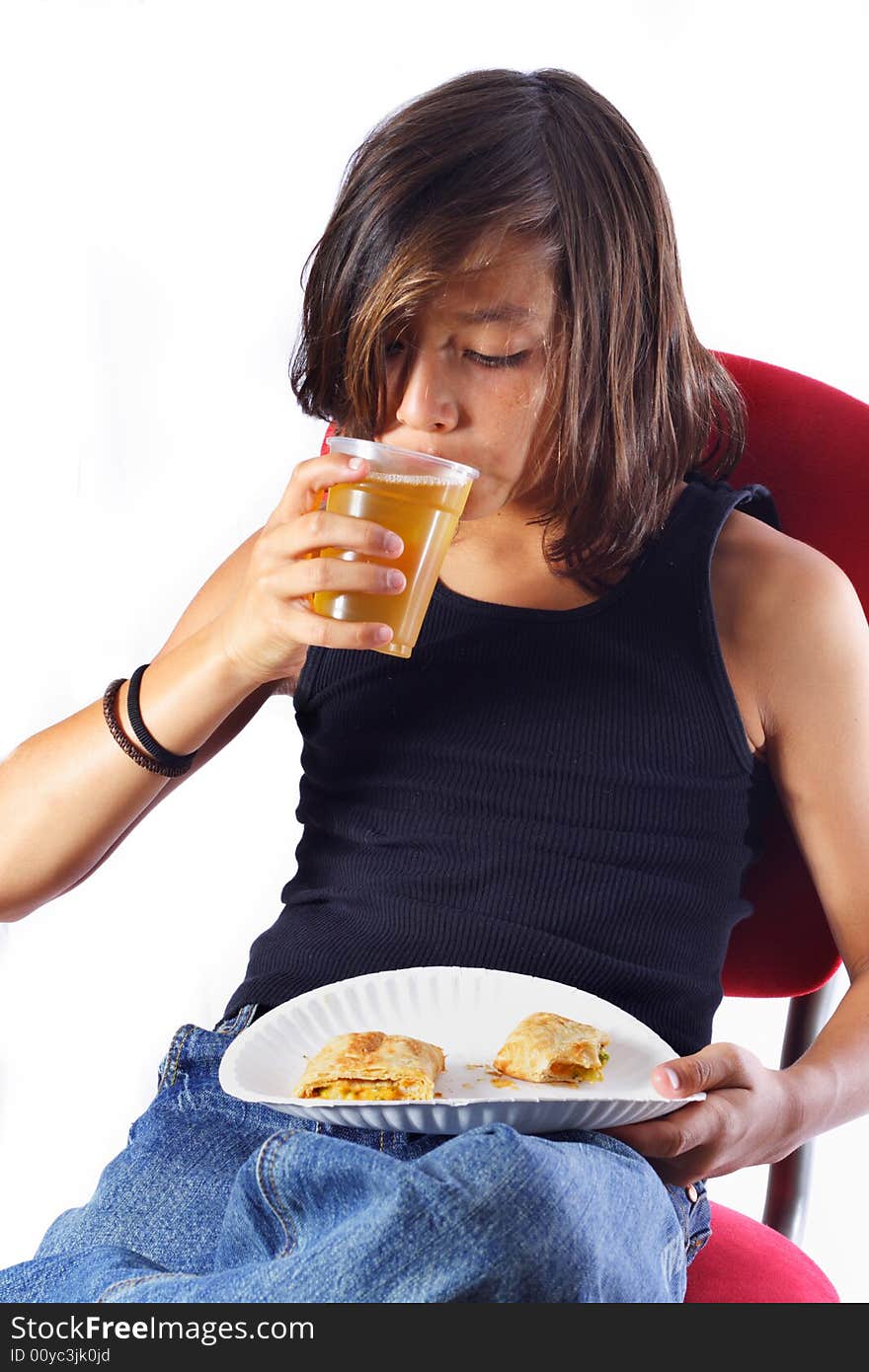 Boy taking a sip of apple juice with his lunch.