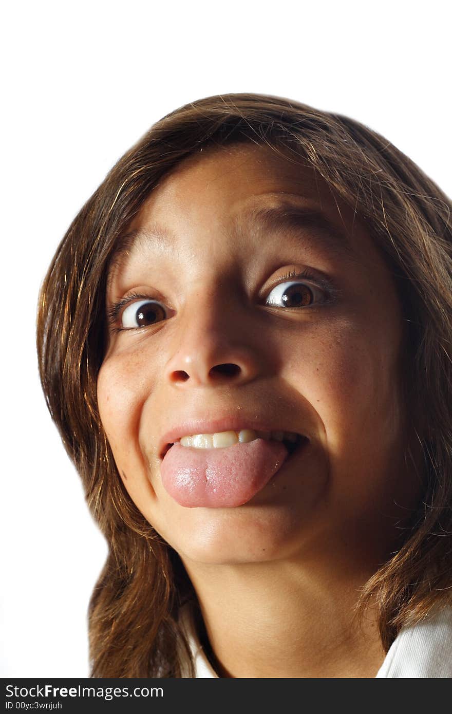 Young boy sticking out his tongue and smiling.