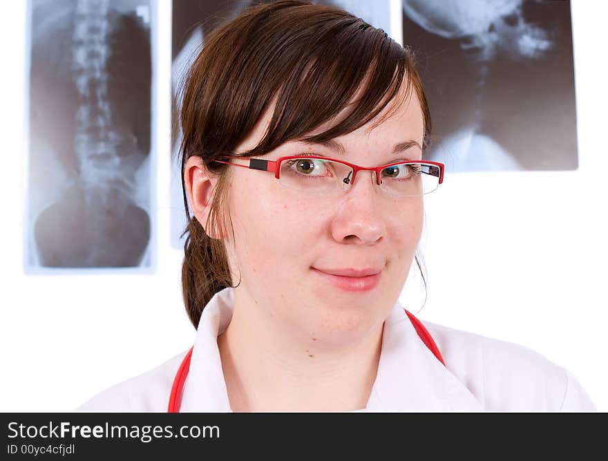 Young female doctor, three x-rays as background, isolated on white. Young female doctor, three x-rays as background, isolated on white