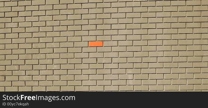 Gray Brick wall with one red brick