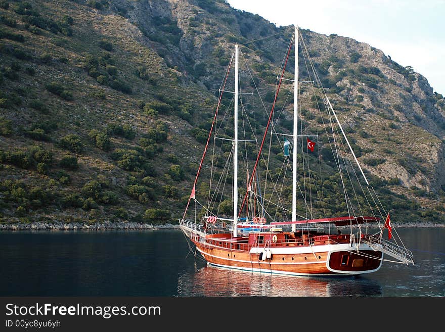 Brown sailing boat on the still water