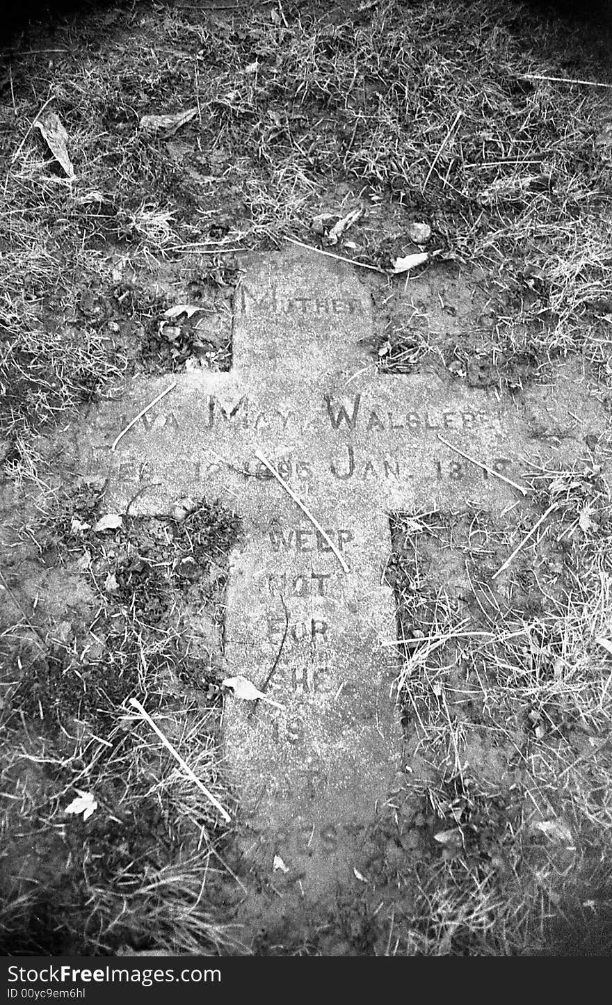 Grave Stone Covered In Debris