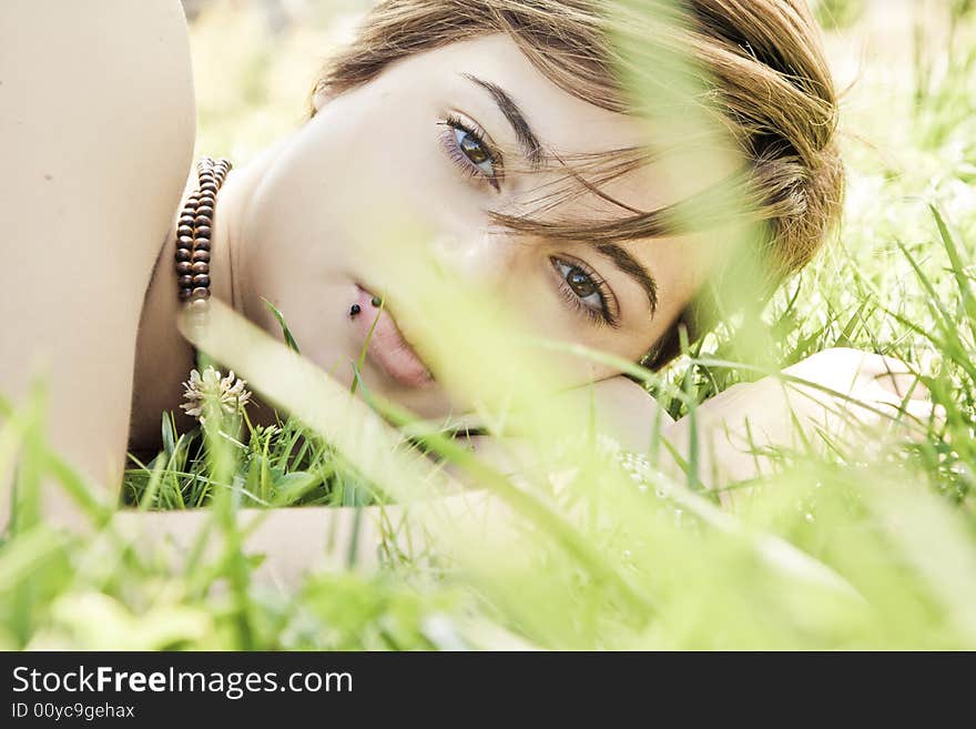 Blonde behind grass