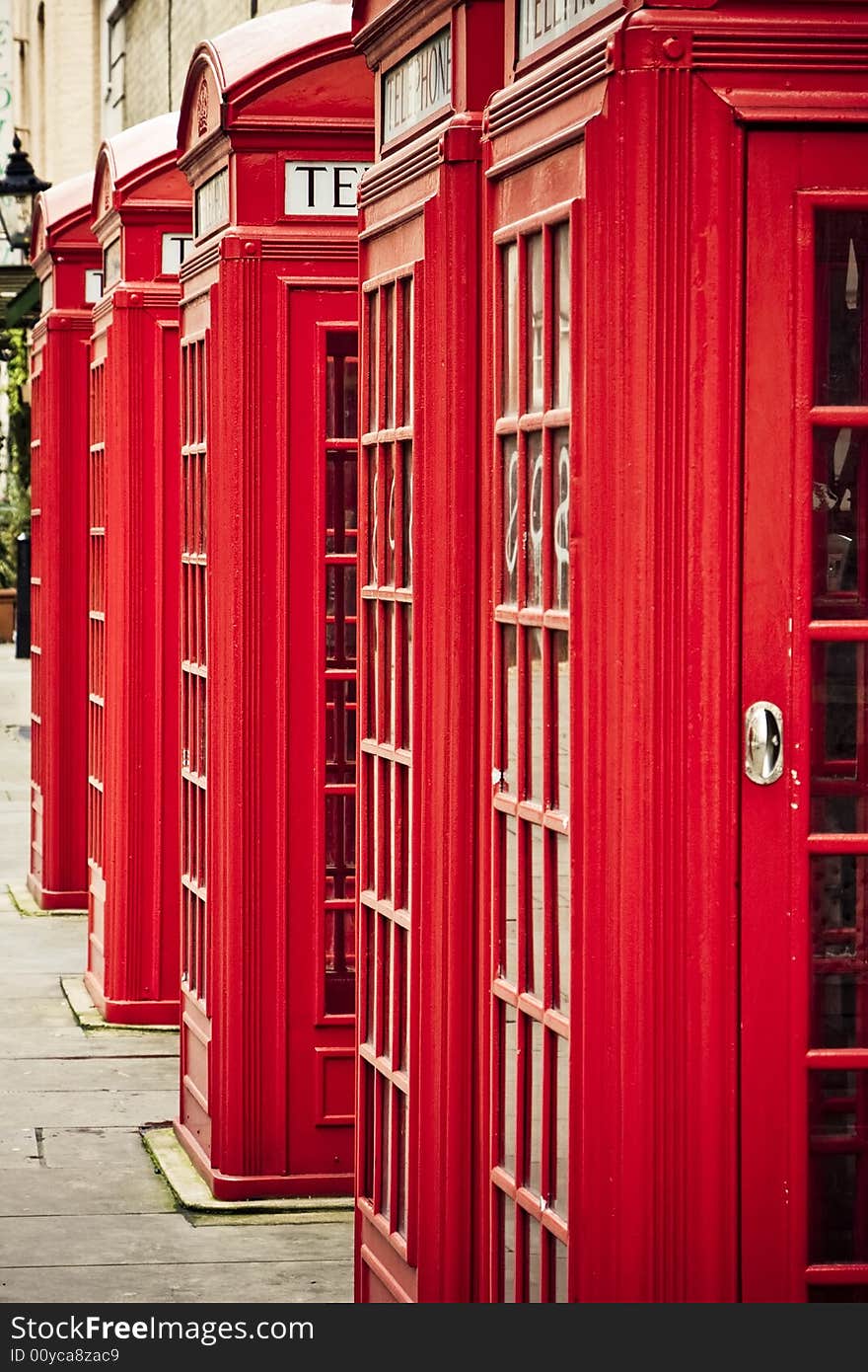 Five red phone boxes, grunge toned