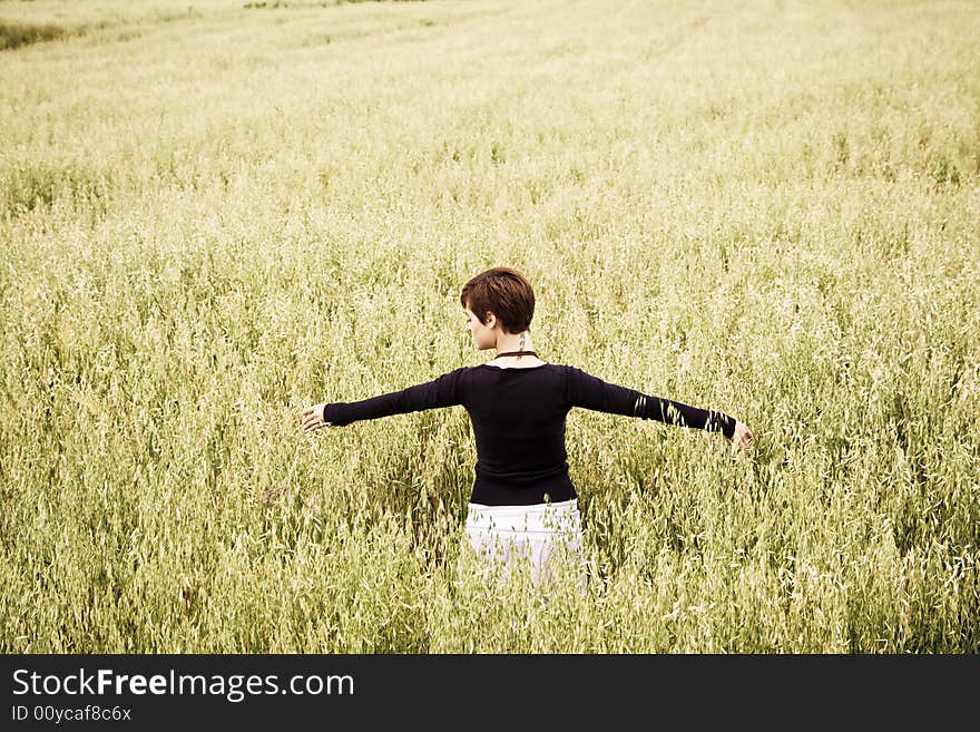 Woman feeling freedom in a field. Woman feeling freedom in a field.