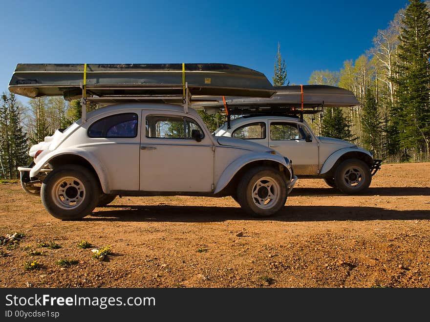 VW Bugs on mountain expidition with canoes. VW Bugs on mountain expidition with canoes