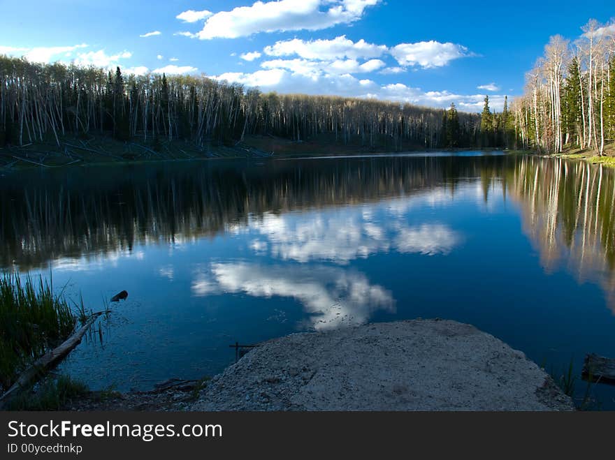 Glassy vacation lake in glorious untouched mountain range in winter. Glassy vacation lake in glorious untouched mountain range in winter