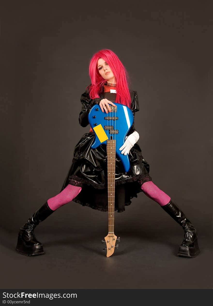 Romantic rock girl in crazy outfit holding bass guitar. Romantic rock girl in crazy outfit holding bass guitar