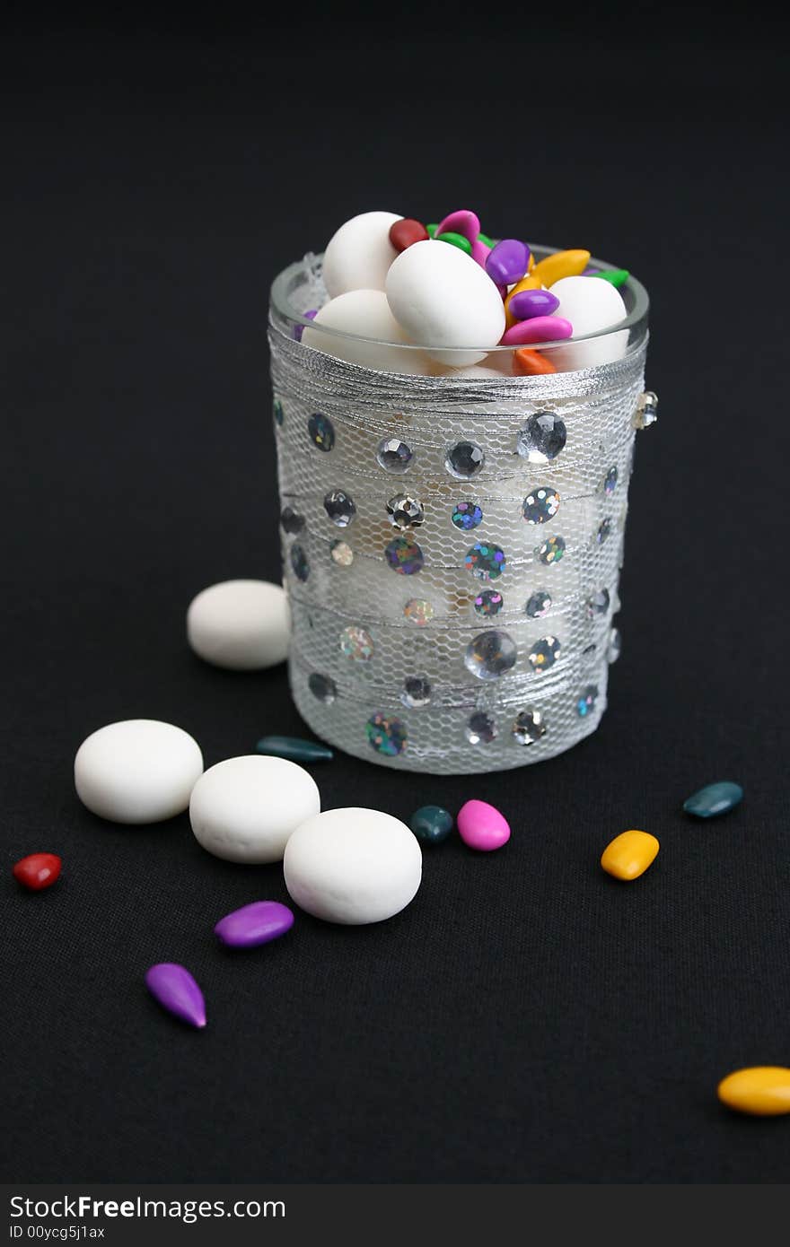 Decorated glass wih mints on a black background