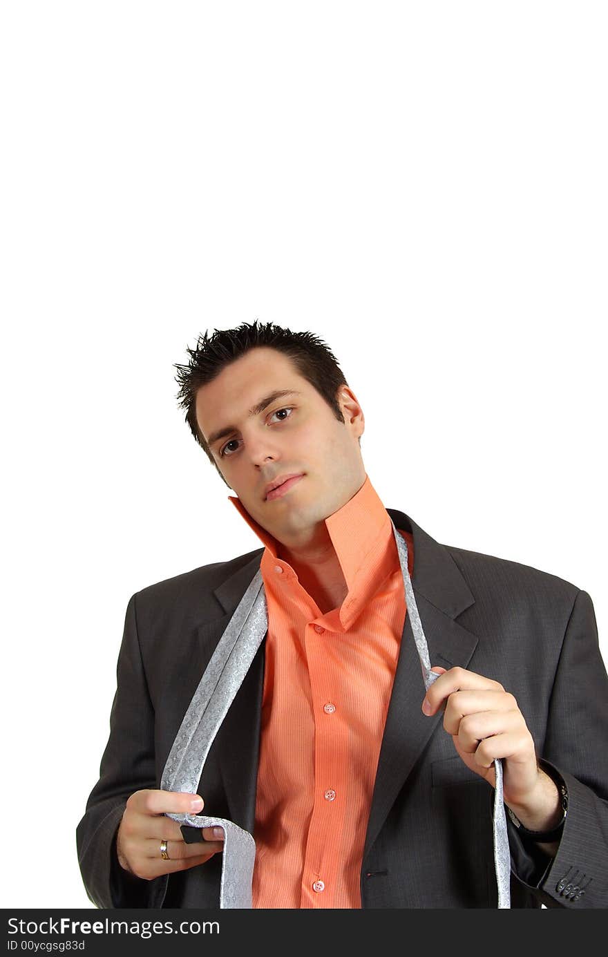 A man, getting dressed, putting his tie, looking at the camera. A man, getting dressed, putting his tie, looking at the camera