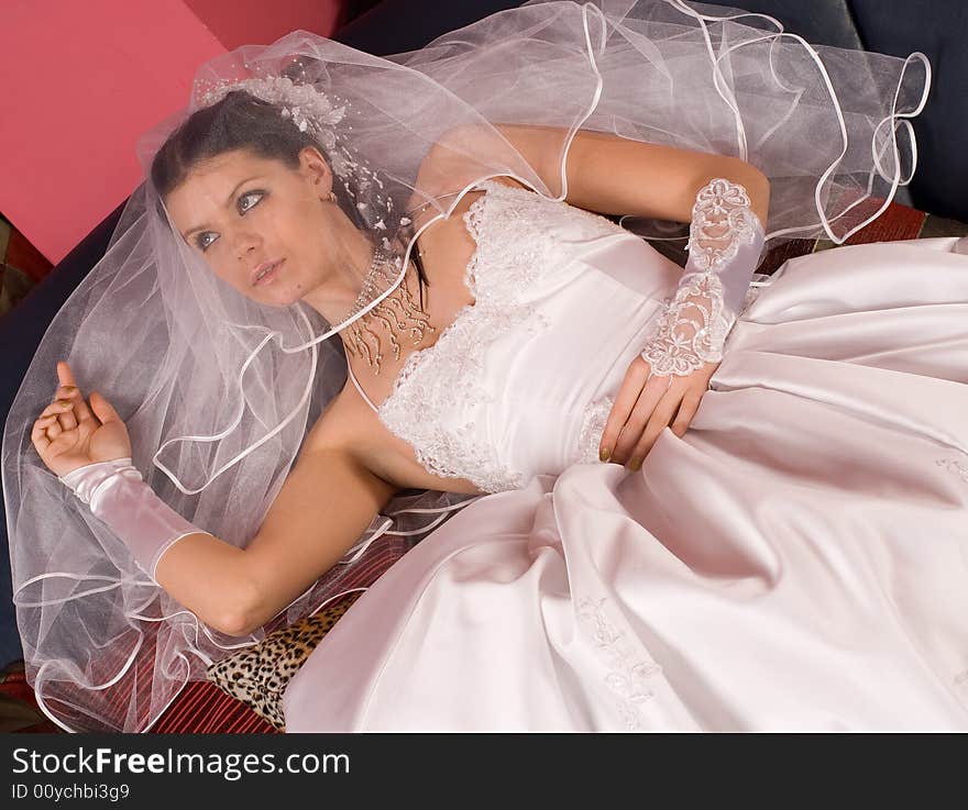 The bride in a wedding dress on beautiful background