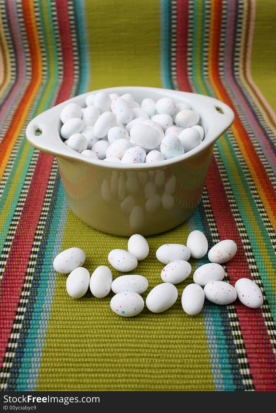 Miniature speckled easter eggs in a green bowl