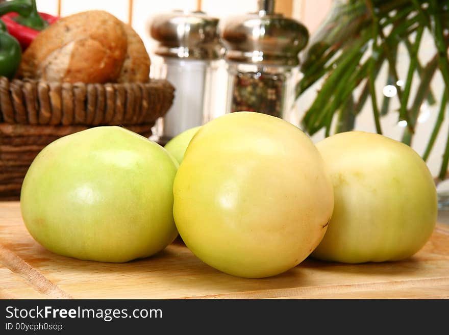 Green tomatoes in kitchen or restaurant.