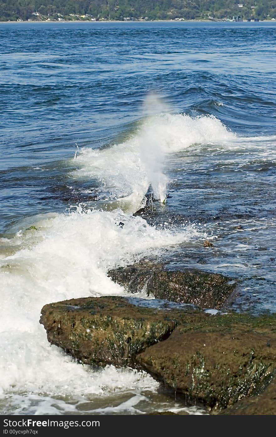 Water crashing against a rocky shoreline. Water crashing against a rocky shoreline