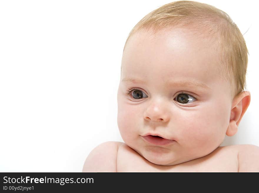 Naked six month old baby lying on his back isolated on white