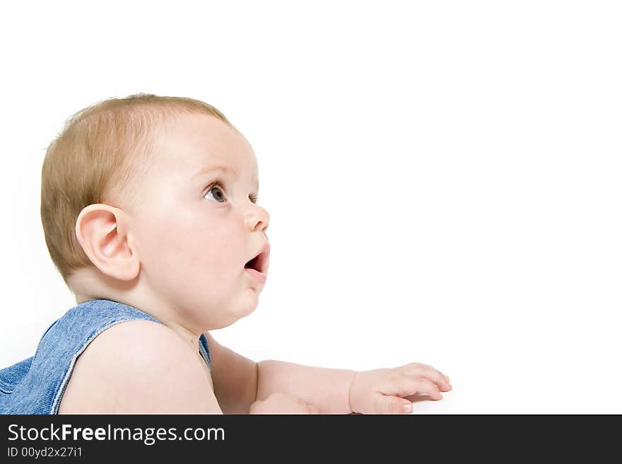 Six month old baby wearing jeans overall with the american flag isolated on white. Six month old baby wearing jeans overall with the american flag isolated on white