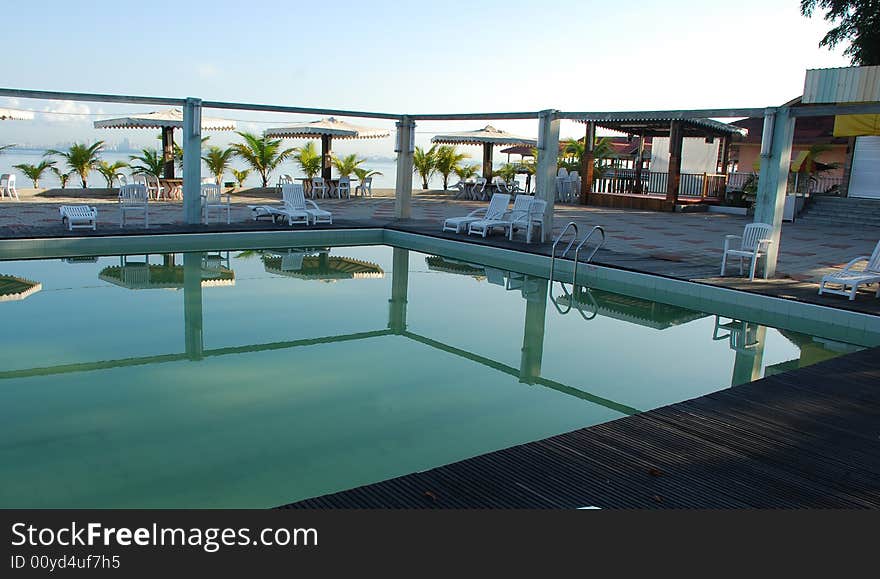 Picture of a resort's swimming pool ideal for resort or holiday context. Picture of a resort's swimming pool ideal for resort or holiday context