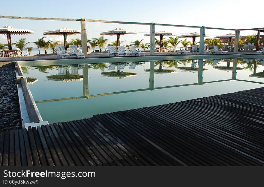 Picture of a resort's swimming pool ideal for resort or holiday context. Picture of a resort's swimming pool ideal for resort or holiday context