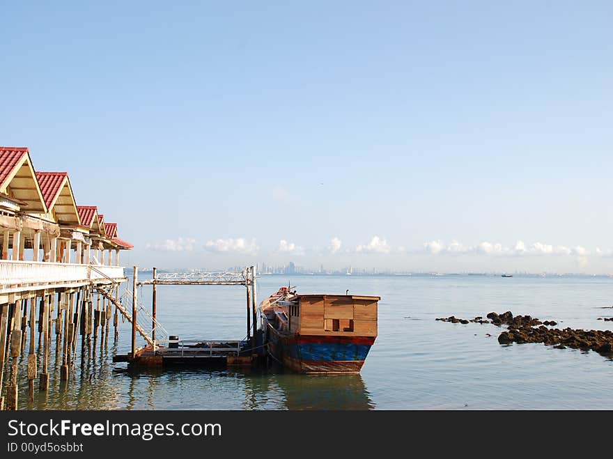 Olden Junk berthing by the side of a kelong (Sea Village). Suitable for resort, 2nd world country descriptions. Olden Junk berthing by the side of a kelong (Sea Village). Suitable for resort, 2nd world country descriptions.