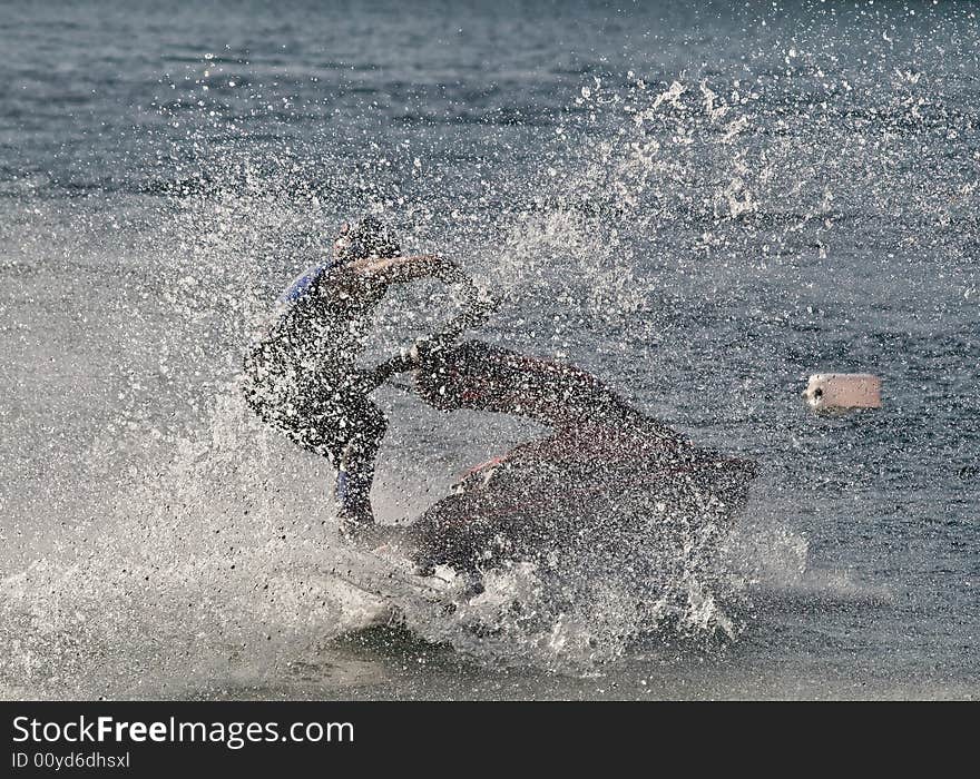 Jet ski in full speed creating splashes as it moves