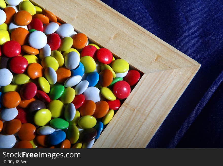 Many colored candies and a frame