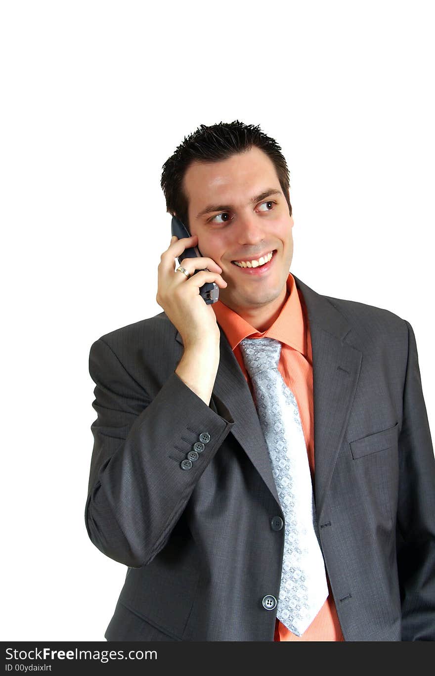 A young businessman, wearing suit, talking over the phone, looking very happy and satisfied. A young businessman, wearing suit, talking over the phone, looking very happy and satisfied