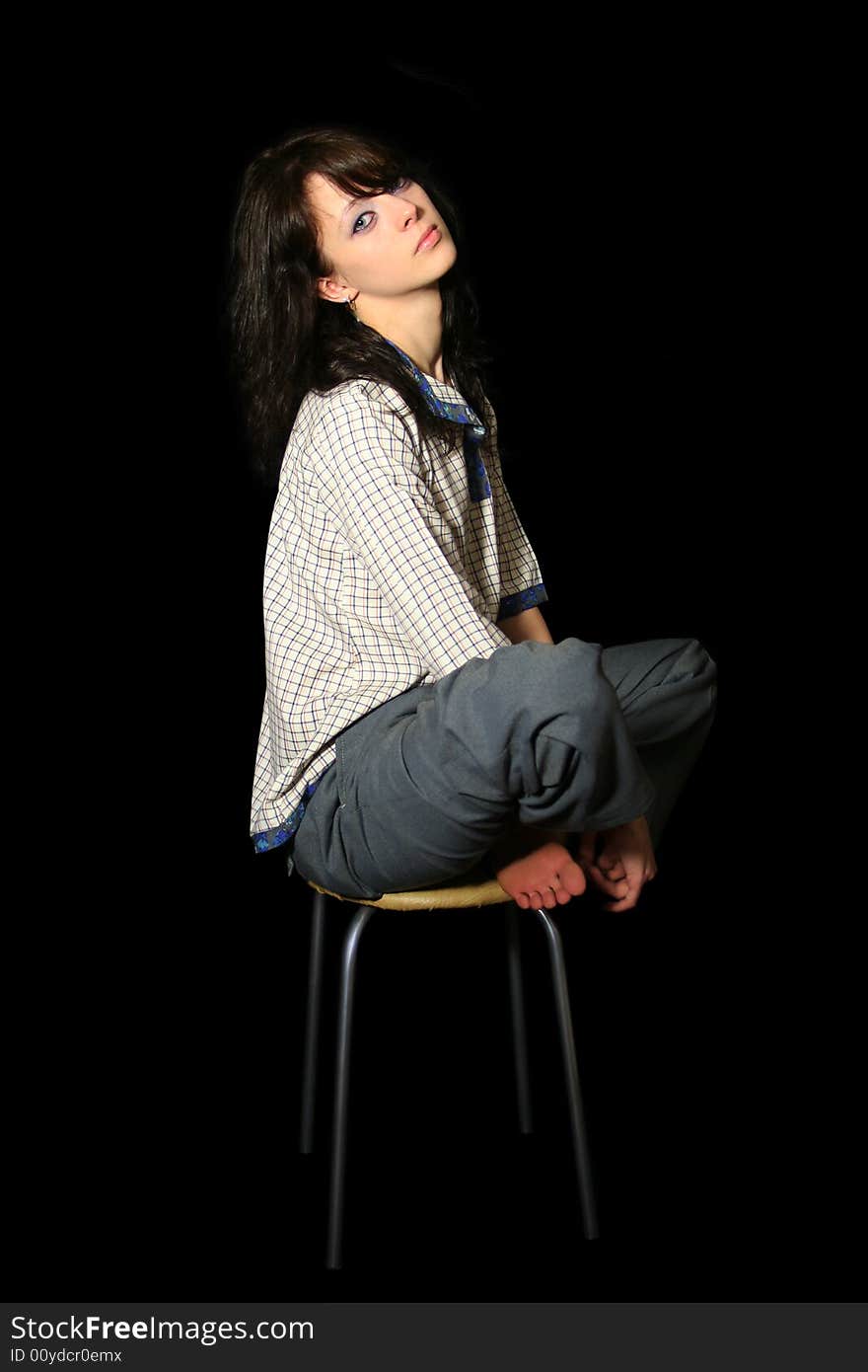 Young woman in village shirt sits on the chair. Young woman in village shirt sits on the chair