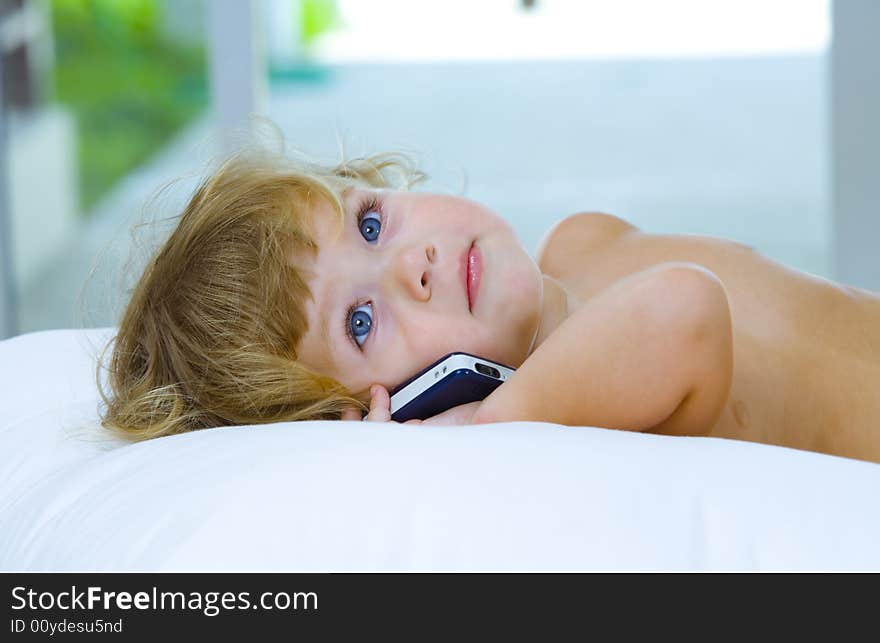 High key portrait of young baby with mobile phone. High key portrait of young baby with mobile phone