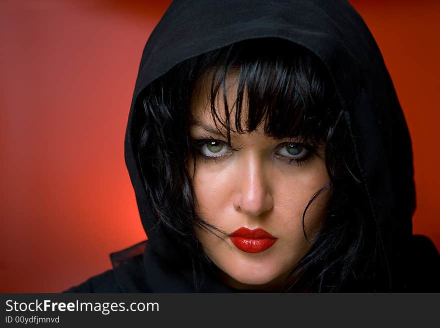 Portrait of young nice woman in black veil on red back. Portrait of young nice woman in black veil on red back