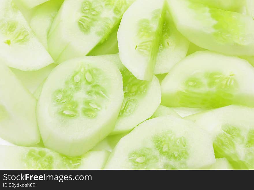 Cucumber slices into pieces as background.