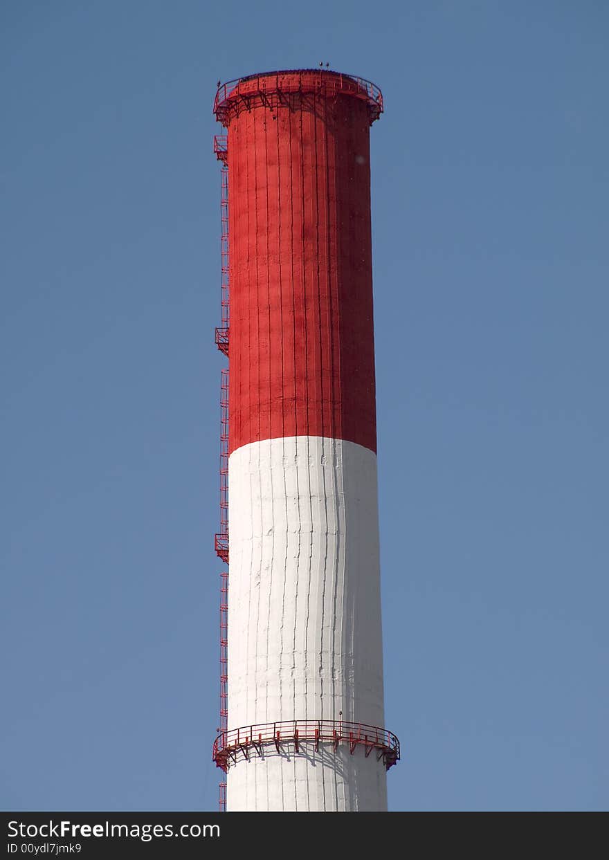 Red and white striped chimney of a power station. Red and white striped chimney of a power station