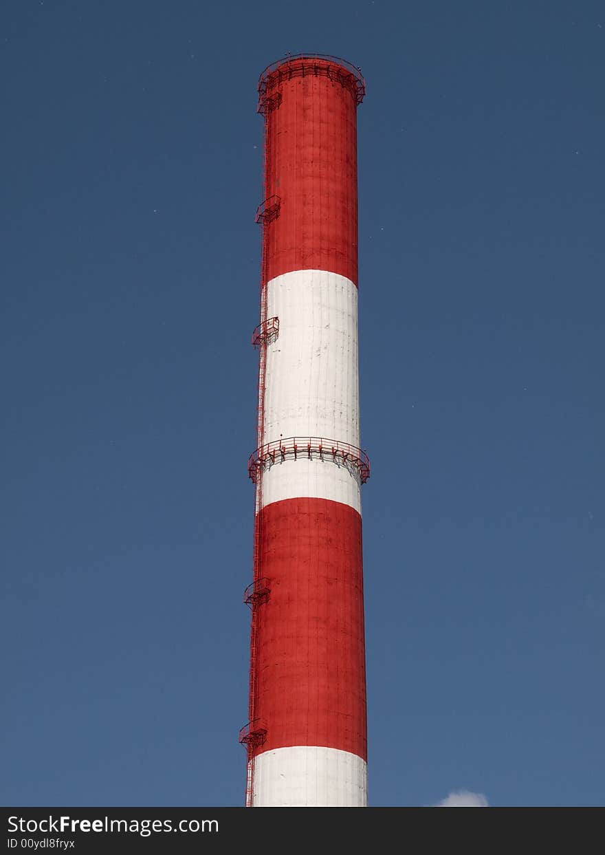 Red and white striped chimney of a power station. Red and white striped chimney of a power station