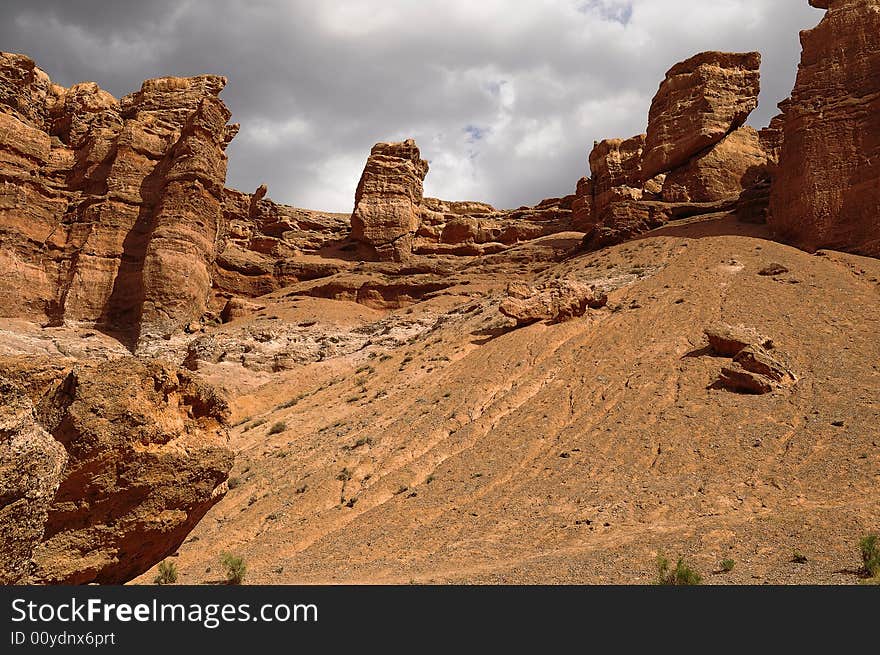 High sand arena rock and cloudy sky. High sand arena rock and cloudy sky